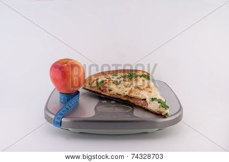 Pizza Apple and Tape measure on Scales