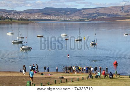 Spectators At Waters Edge Cheering Triathlon Swimmers