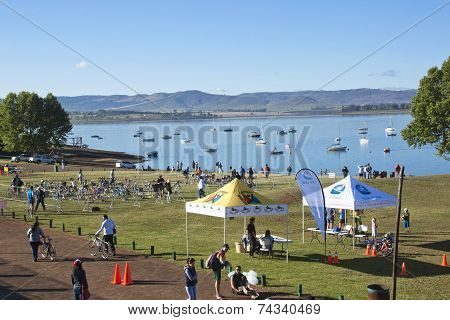 Participants And Spectators On Grass Bank Of Dam
