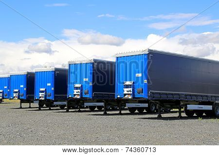 Row Of Blue Trailers On A Yard