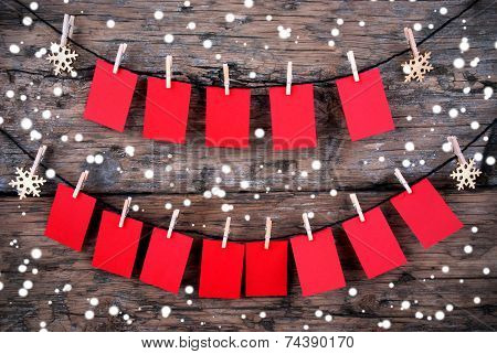 Red Tags With Copy Space Hanging In The Snow On Wooden Background