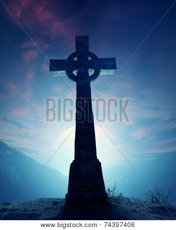 Celtic Cross with moonscape on crest of rocky mountain