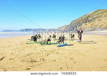 VALE FIGUEIRAS, PORTUGAL - July 21 2014: Surfers doing excersises on the famous surfers beach Vale Figueiras in Portugal