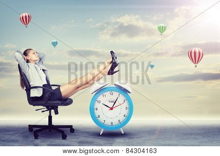 Woman in jacket and skirt sitting on chair. Background of clouds, hot air balloon