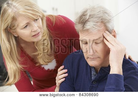 Mature Woman Comforting Man With Depression