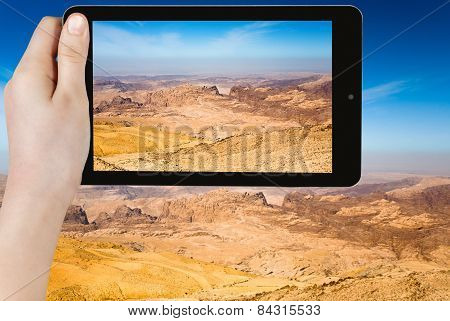 Tourist Taking Photo Of Mountain Panorama