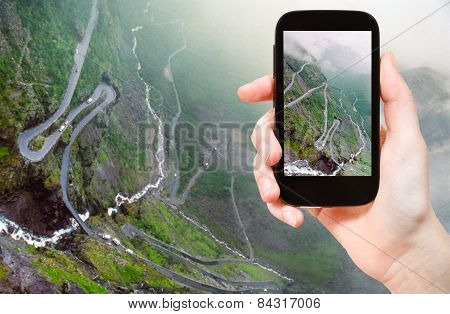 Tourist Taking Photo Of Trollstigen
