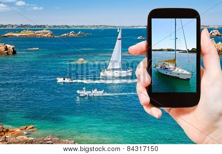 Tourist Taking Photo Of Yacht Near Brittany