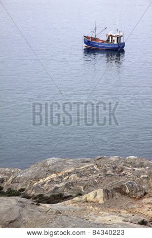 Lone boat bobbing in Luderitz Harbour, Namibia.