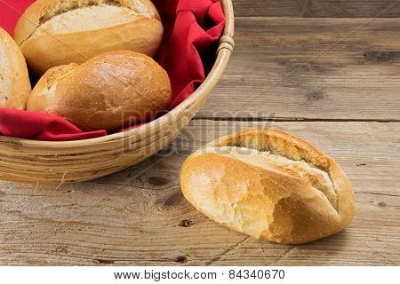 Bun And Bread Rolls In A Basket Whith Red Napkin On Old Wood