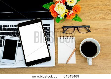 Laptop And Cup Of Coffee With Flower On Desk