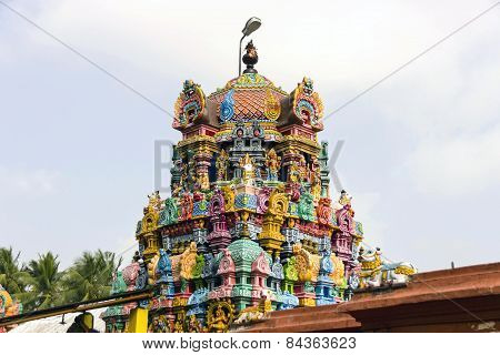 Magnificient colourful Gopuram against a blue sky background