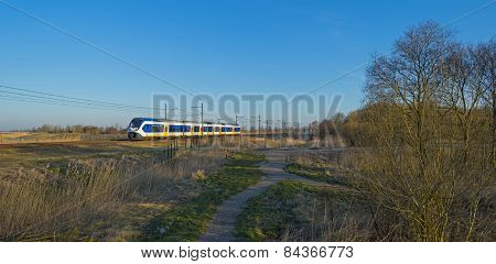 Train moving through the countryside in winter
