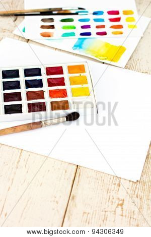 Workplace artist - paper paint brushes color wheel