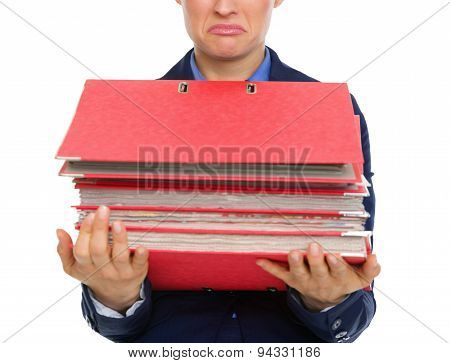 Closeup Of Upset Businesswoman's Hands Holding Stack Of Folders