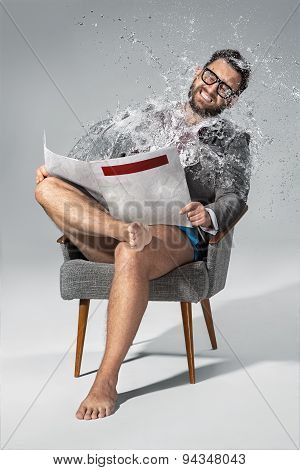 Man reading newspaper on gray background