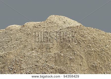 Pile of natural unsifted dirt with small pebbles and stones embedded - isolated on a blue backgroun