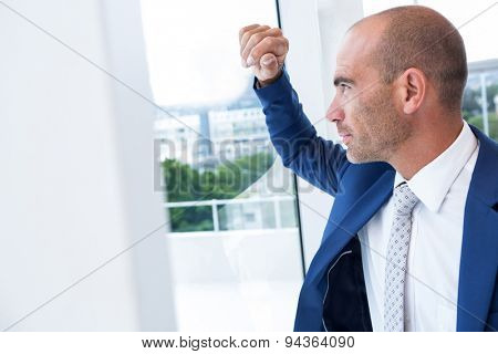 Serious businessman looking away in the offie