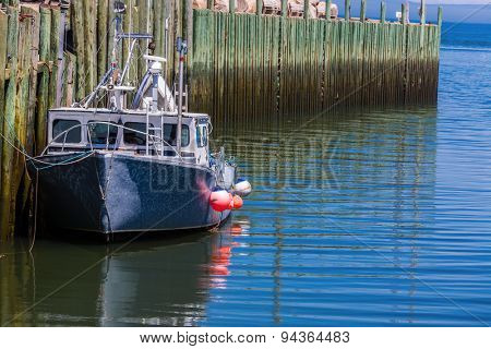 A lobster fishing boat tied up at the wharf in Hall's Harbour, Nova Scotia.