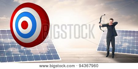 Businessman shooting a bow and arrow against solar panels on floorboards in the sky