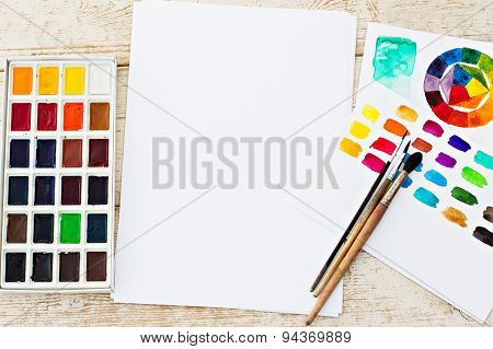 Workplace artist - paper paint brushes color wheel