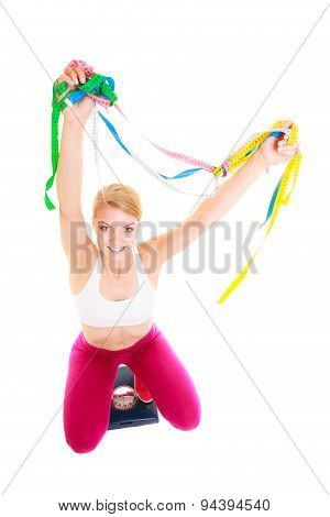 Joyful Woman On Weighing Scale. Slimming Diet.
