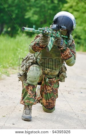 military. soldier in uniform targeting with assault rifle outdoors