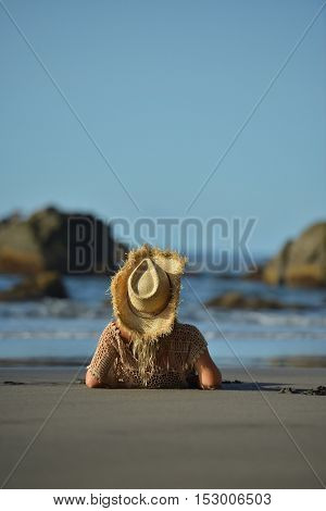 young woman relaxing on the beach in summer day