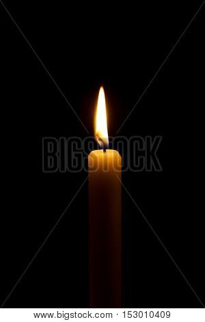 burning candlelight in a church over black background.