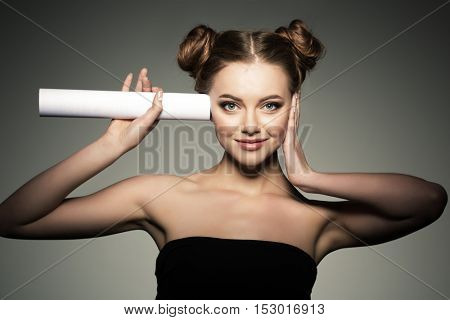 Beautiful girl listens in the paper roll. Woman couting news and gossip. 