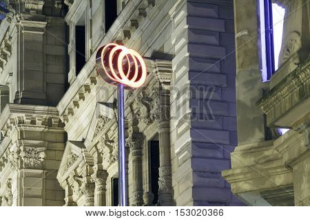 BILBAO, SPAIN - OCTOBER 24, 2016: Detail of the exterior logo of the Bilbao city subway at night designed by Otl Aicher and sited in all of the entrances of the Bilbao city subway.