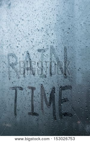 wording raintime on glass - raindrops on window