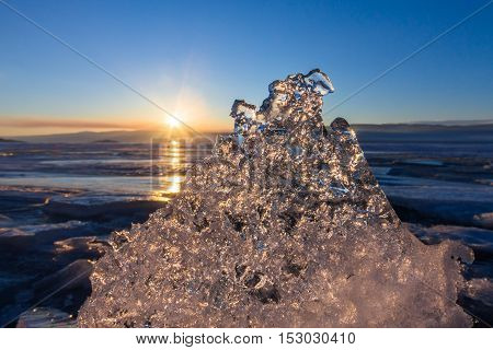 Sun At Sunset Shining Through The Transparent Texture Of The Ice Floe In Lake Baikal