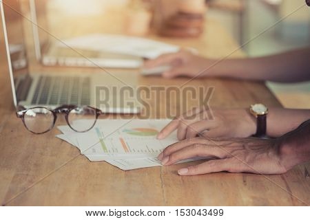 Hands of two business people working at meetingvintage effect.
