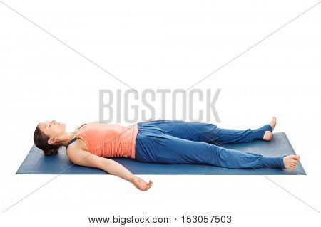 Yoga relaxation - beautiful sporty fit woman relaxes in yoga asana Savasana - corpse pose isolated on white