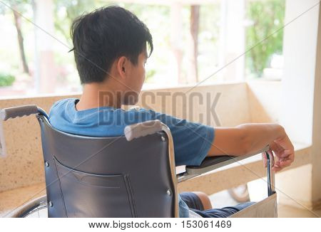 patient in wheelchair parked in hospital with selective focus.