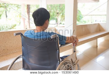 patient in wheelchair parked in hospital with selective focus.