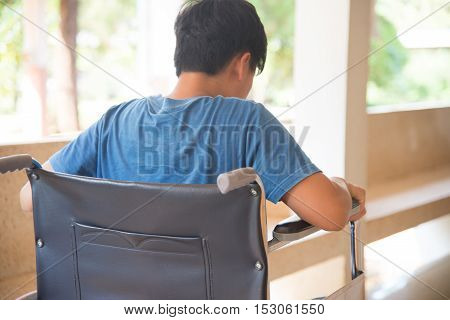 patient in wheelchair parked in hospital with selective focus.