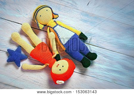 Crochet Toys Couple Laying On A Wooden Background With Copy Space For Your Text