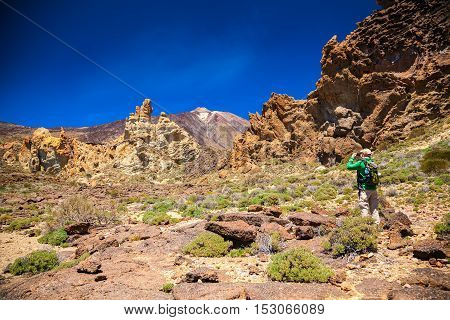 tourist man taking picture at the Teide National Park Tenerife Canary Islands Spain