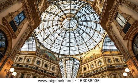 October 23 2015 - Milan Lombardy Italy : Low angle view toward circular domed ceiling and windows inside the Vittorio Emanuele Milan shopping mall interior