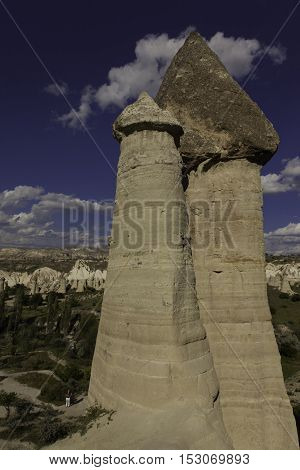 Prehistoric rock formations in front of Love valley in Turkey shot during cloudy day