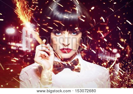 Sexy mafiosi woman with cigar sparking outdoor