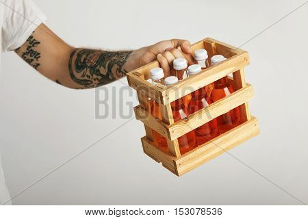Man In Unlabeled White T-shirt With Box Of Orange Drinks
