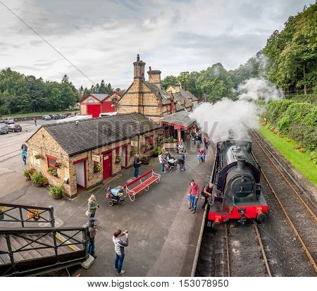 Tourists waiting at Haverthwaite Station part of Lakeside and Haverthwaite Railway. 3 image panorama. Haverthwaite, Cumbria, England, UK: - October 4, 2016.