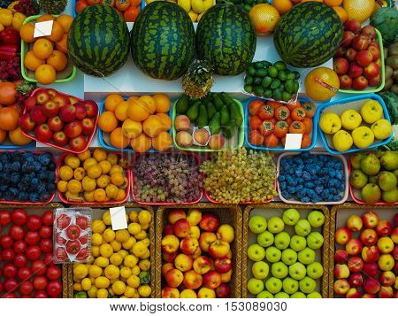 A wide range of fruits and vegetables on the market. View from the top of the counter
