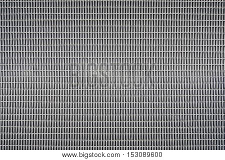 Background sheet of metal covered with abstract lines of holes
