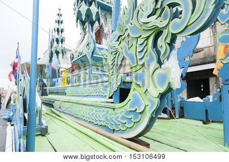 Suratthani, Thailand - October 20, 2016: Details on ornamented carriers of Buddha images to be pulled across the city during the famous Chak Phra Festival, an annual Buddhist festival to celebrate the return of Buddha from heaven to earth after the end of