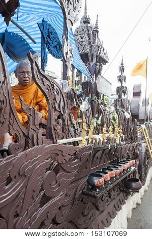 Suratthani, Thailand - October 20, 2016: Buddhist monk sitting on ornamented carriers to be pulled across the city during the famous Chak Phra Festival, an annual Buddhist festival to celebrate the return of Buddha from heaven to earth after the end of th