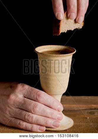 chalice of wine and bread on the dark background